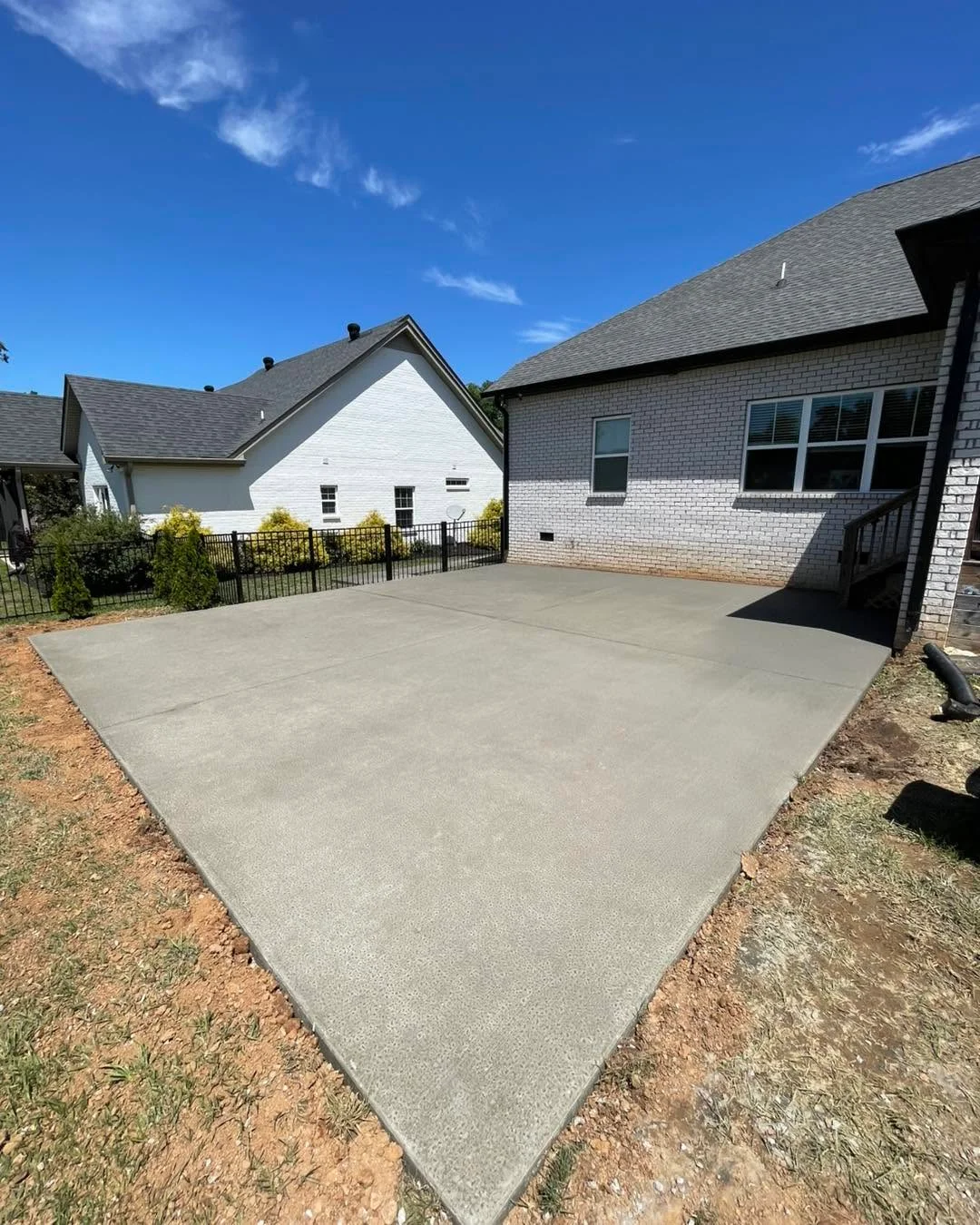 Concrete driveway at a white Clarksville home