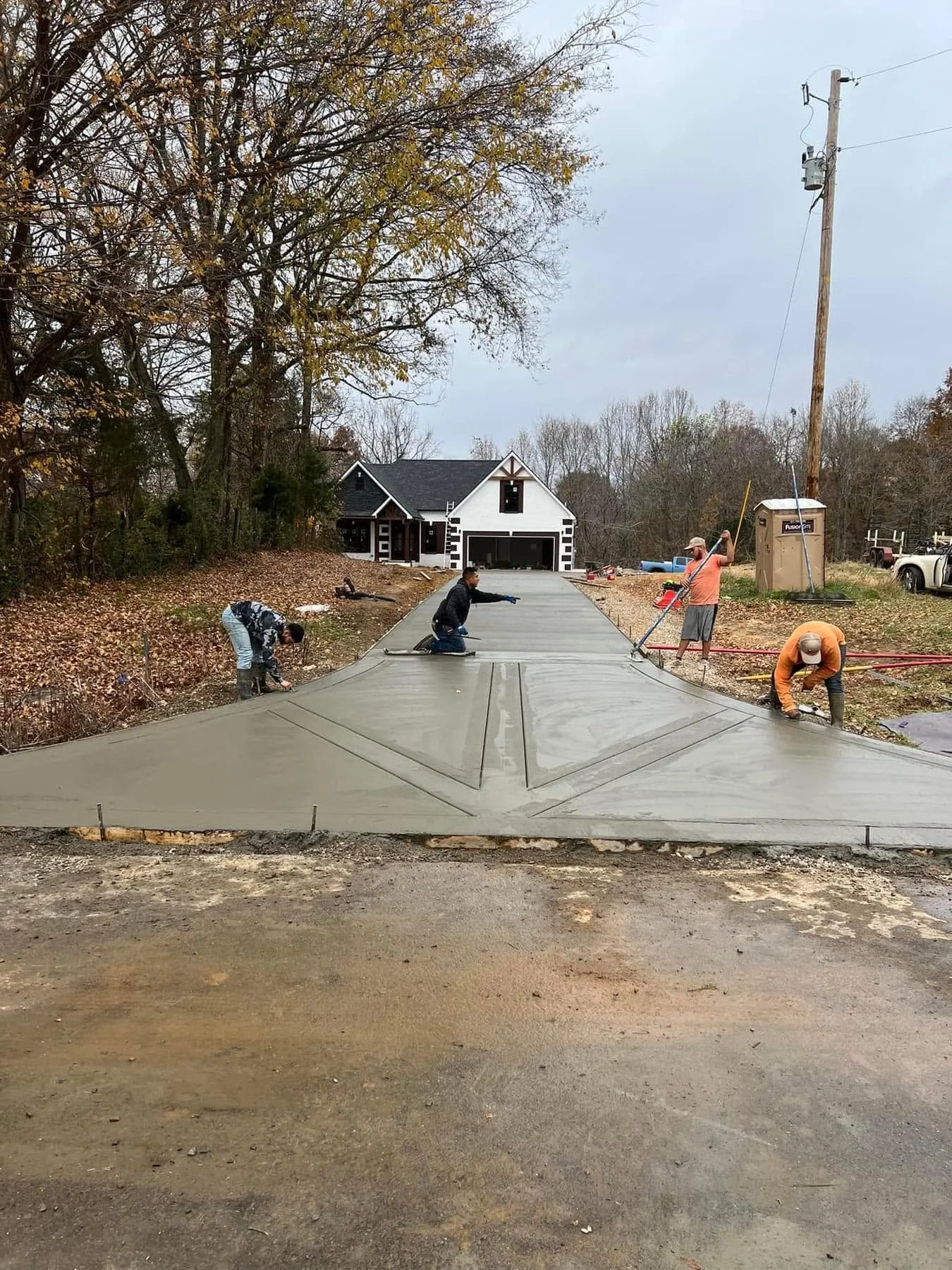 Freshly poured concrete driveway by Elite Concrete Clarksville in a Sango, TN neighborhood.