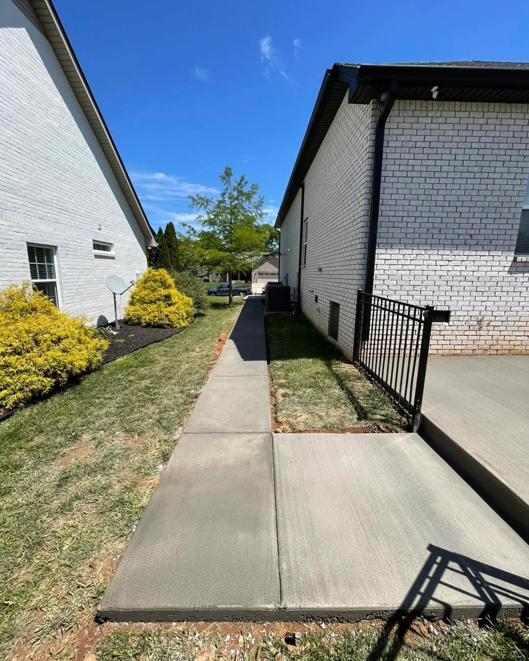 Concrete sidewalk between Clarksville homes
