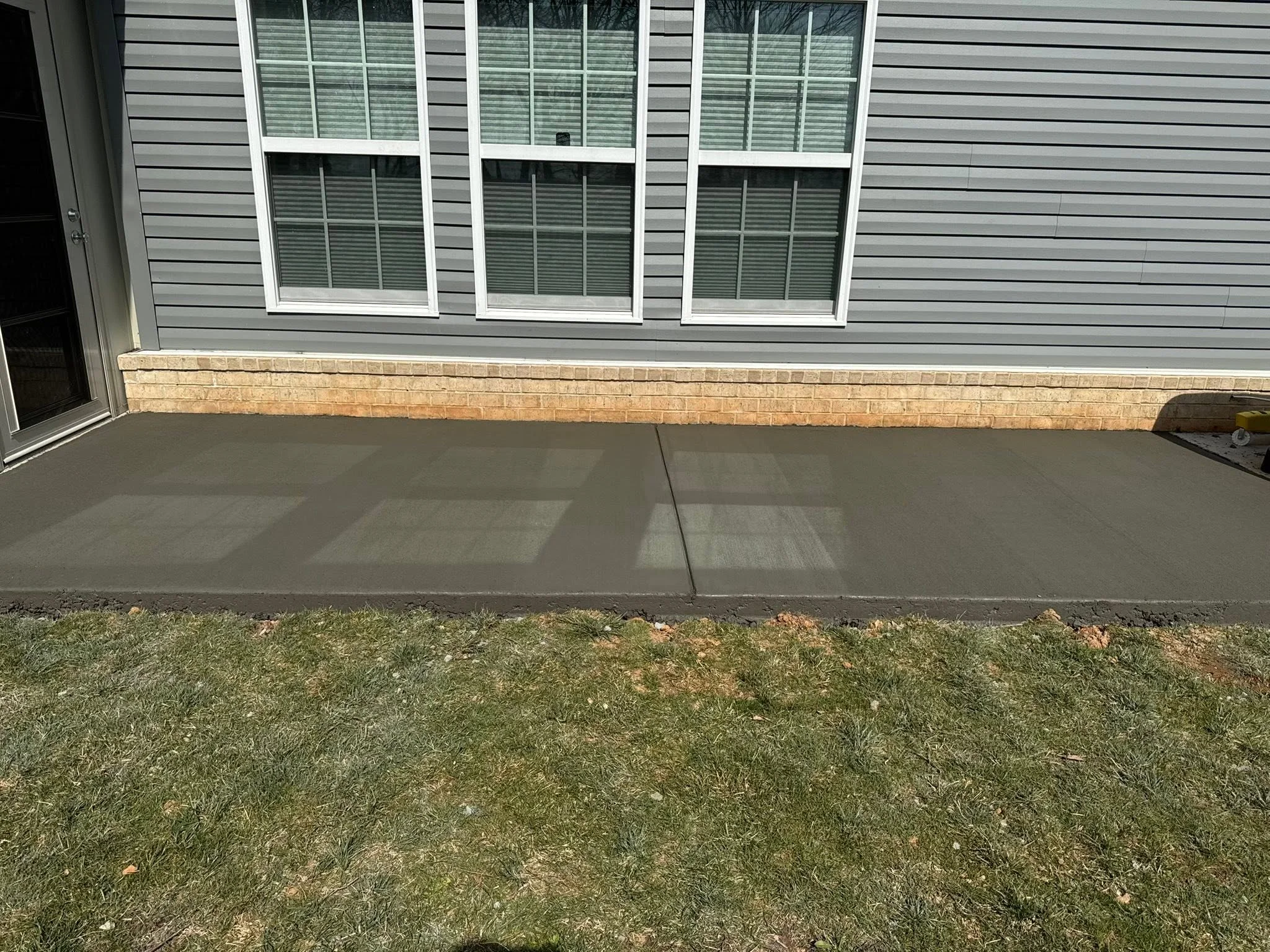 Narrow concrete walkway beside a Clarksville home